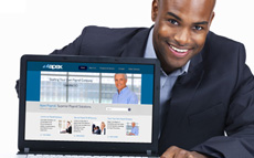 Photo of a young man with a computer screen showing the Apex Payroll website